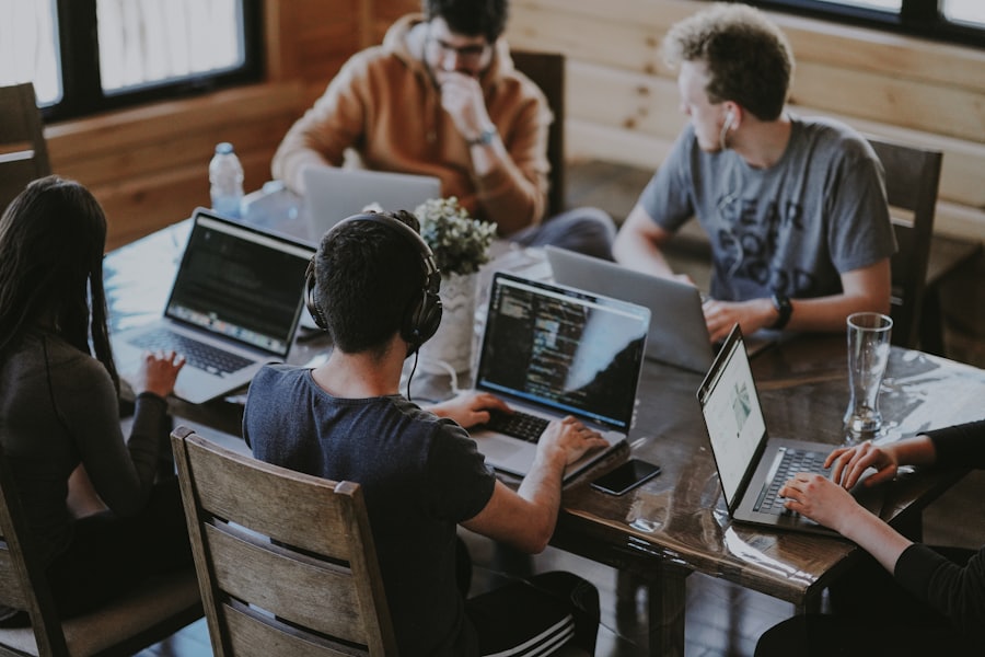 A team collaborating on laptops around a table